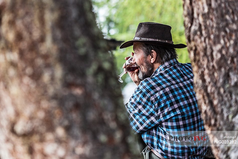 Old man drinking red wine, South Tyrol, Dolomites, Italy 