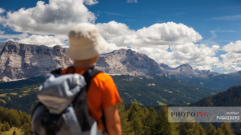 Little hiker admires the Sasso della Croce mountain, Val Badia, dolomites, italy