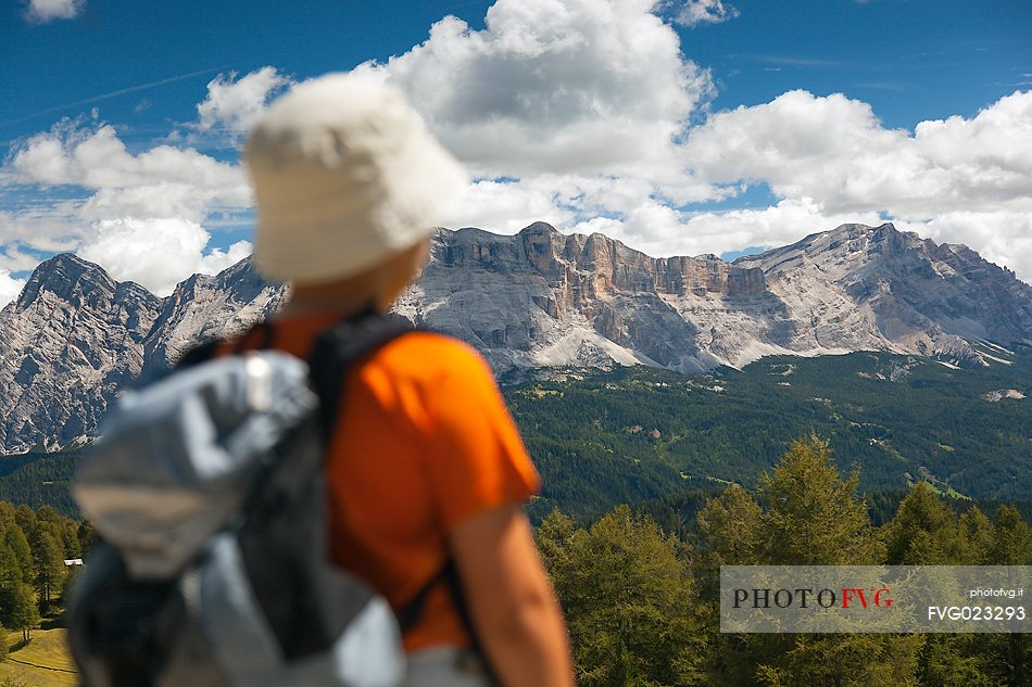 Little hiker admires the Sasso della Croce mountain, Val Badia, dolomites, italy