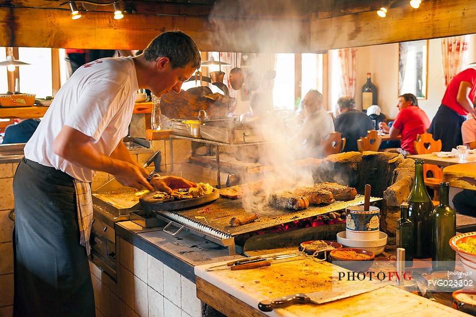 Barbecue in Scotoni hut, Badia Valley, South Tyrol, Dolomites, Italy