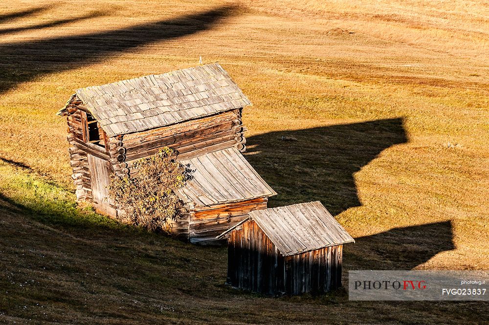 Huts to the Armentara meadows in autumn, Badia Valley, dolomites, Italy