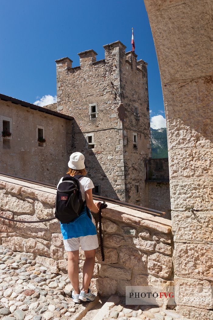 Tourist at entrance of Castel Thun castle,  Val di Non, Trentino, Italy