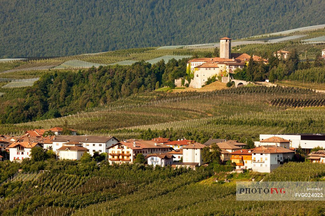 Castel Valer castle and the village in the apple trees valley, Val di Non, Trentino, Italy