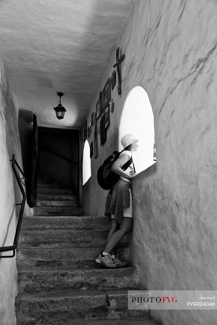 Tourist inside of San Romedio Sanctuary, Val di Non, Trentino, Italy