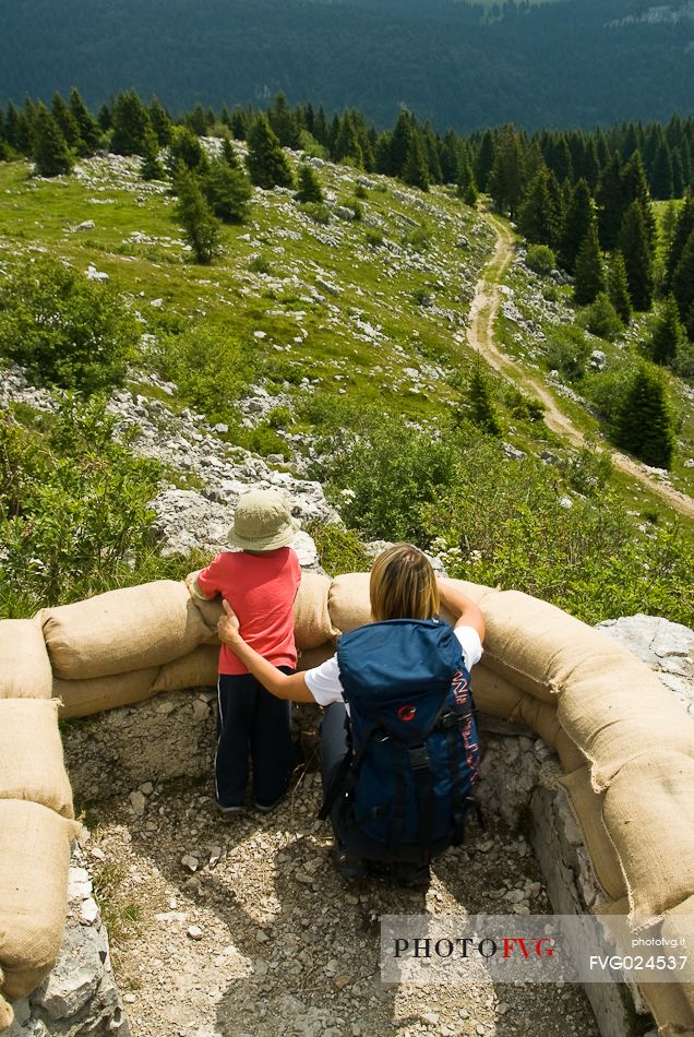 Tourists in the trenches at open-air museum of the Great War on Monte Zebio, Asiago, Italy