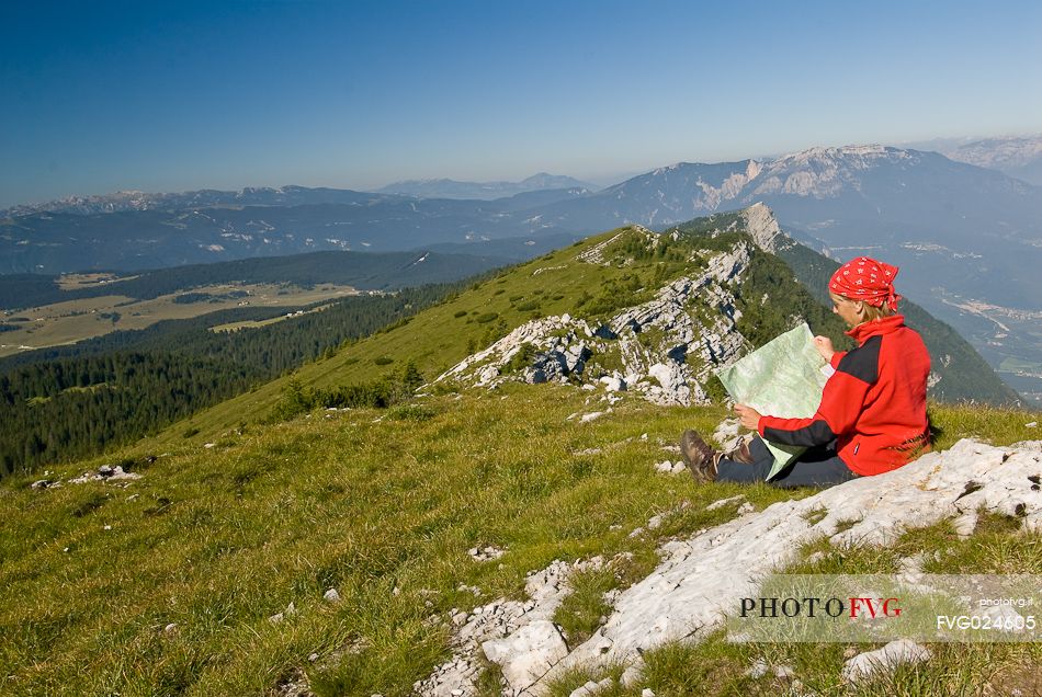 Hiker on the top of mount Manderiolo, Asiago, Italy