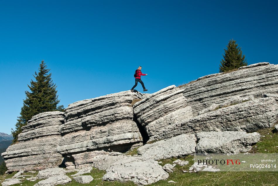 Hiker in the mount Fior, the rocky garden of Asiago plateau, Asiago, Italy