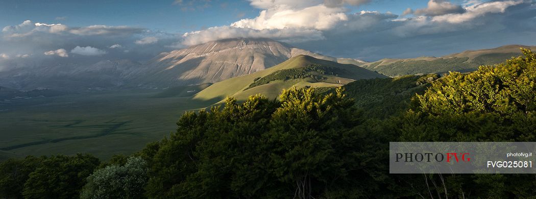 Last lights on Piano Grande Plateau with visible the karst Fosso dei Mergani and in the background Vettore Mount and its fault, Sibillini National Park, Italy