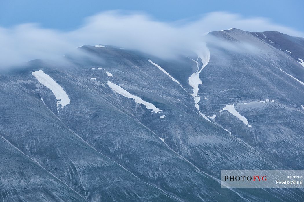 Evening clouds above Monte Vettore mountain, Castelluccio di Norcia, Italy