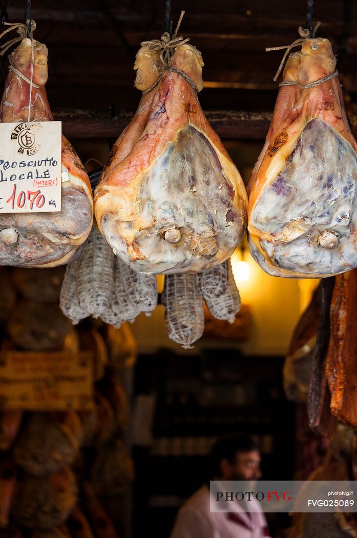 The famous Norcia's ham exposed in one of the many shops in the old town, Norcia, Italy