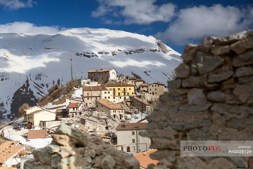 Castelluccio di Norcia, the old village destroyed by the earthquake of 2016, in the background the Vettore montain and its fault, Sibillini national park, Italy