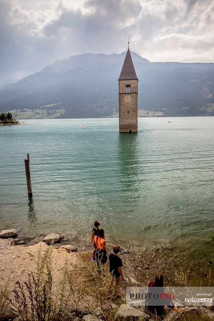 The bell tower in the Resia lake, South Tyrol, Italy