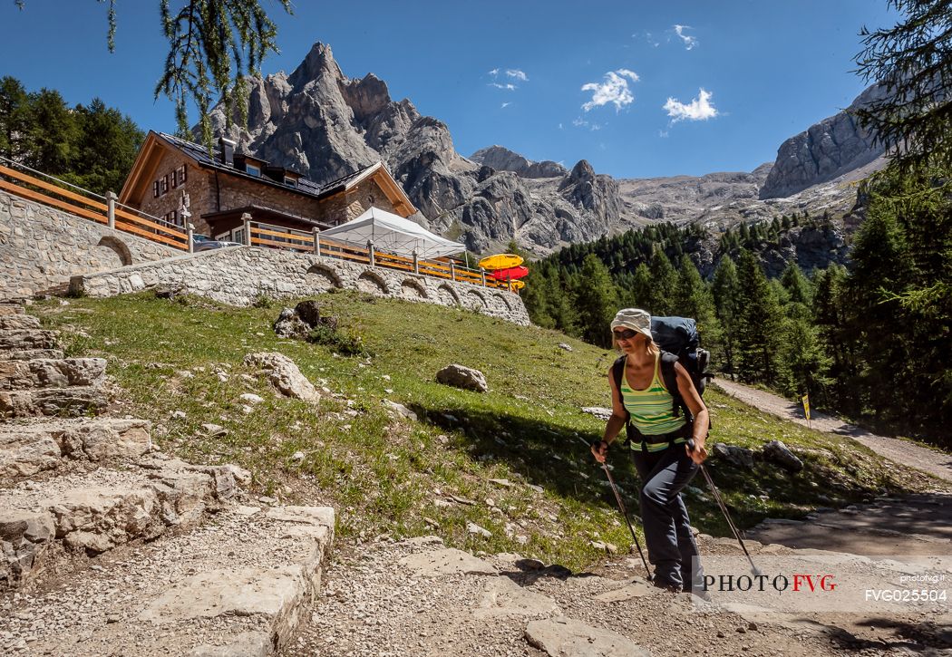 Hiker at Contrin hut, in the background the Marolada range, dolomites, Italy