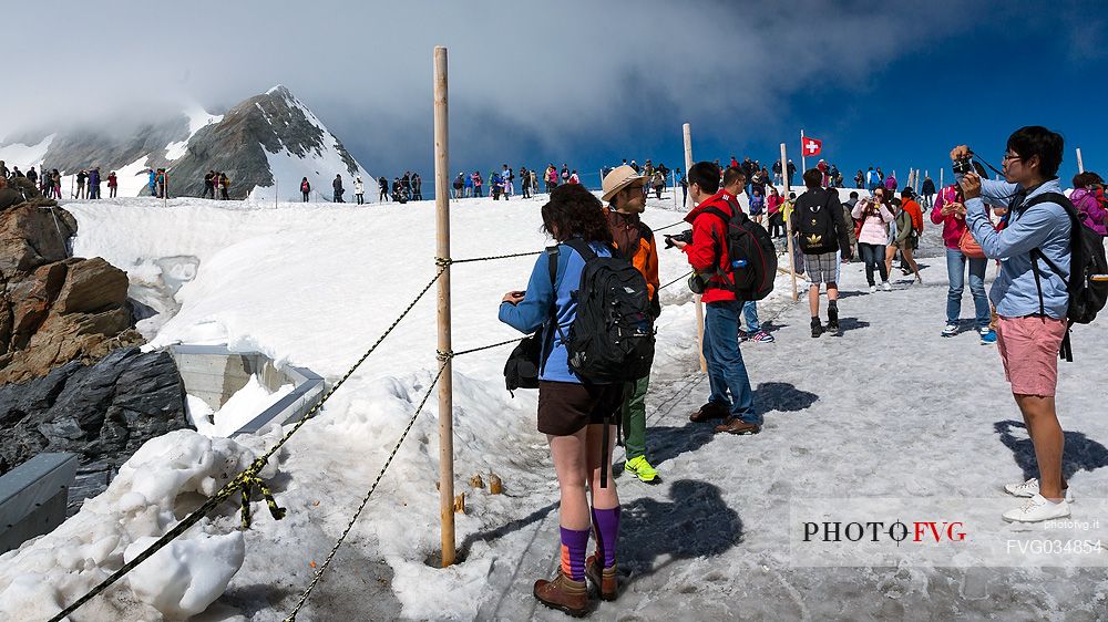 Tourists on the Top of the Jungfraujoch or Top of Europe admiring the Aletsch glacier, the largest in Europe, Bernese alps, Switzerland, Europe