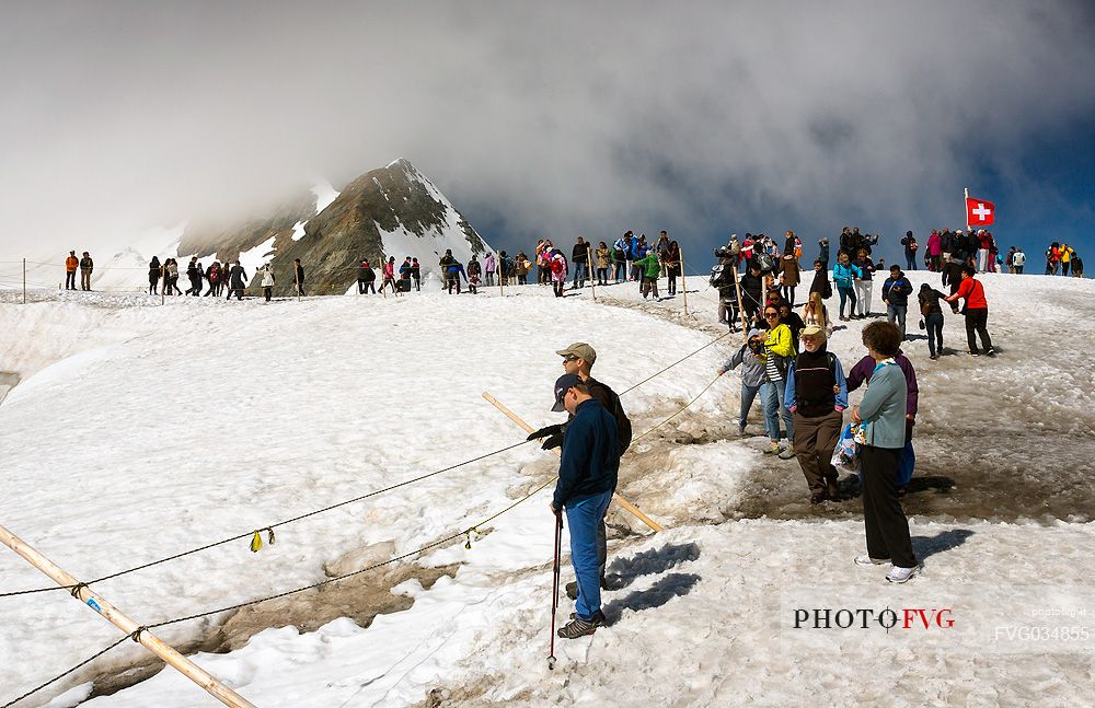 Tourists on the Top of the Jungfraujoch or Top of Europe admiring the Aletsch glacier, the largest in Europe, Bernese alps, Switzerland, Europe