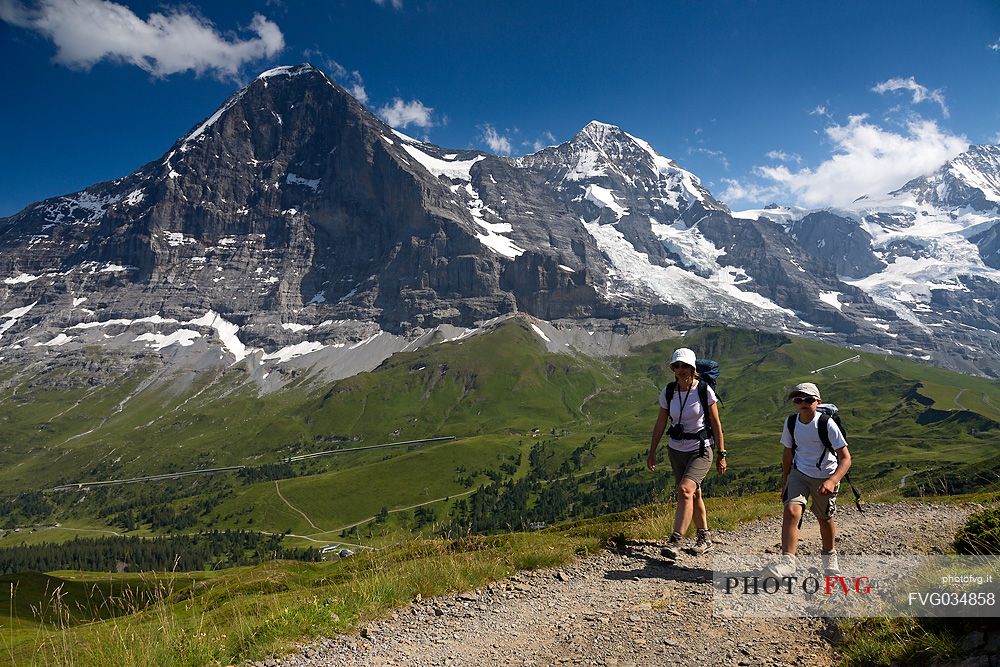 Mother and child in the path from Kleine Scheidegg to Mnnlichen, in front the famous north face of Eiger mount and the Jungfrau mountain group, Grindelwald, Berner Oberland, Switzerland, Europe
 