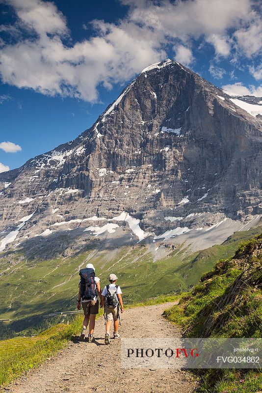 Mother and child in the path from Mannlichen to Kleine Scheidegg, in front the famous north face of Eiger mount and the Jungfrau mountain group, Grindelwald, Berner Oberland, Switzerland, Europe
 