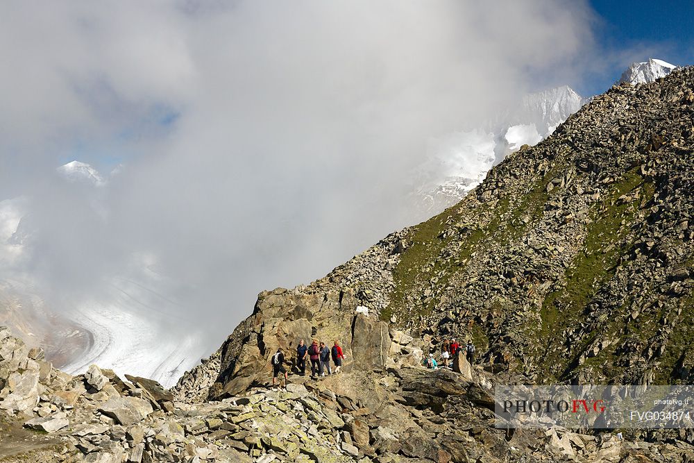 Hikers alogn the path to Eggishorn mountain,  Aletsch glacier, Fiesch, Valais, Switzerland, Europe