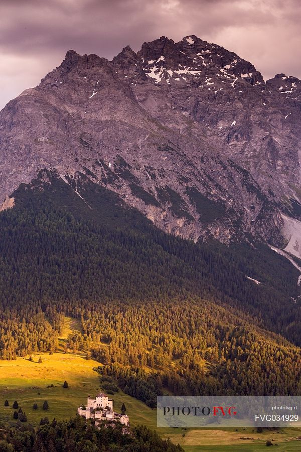 Tarasp Castle at sunset and Mountain of Swiss national park, Lower Engadin, Canton of Grisons, Switzerland, Europe