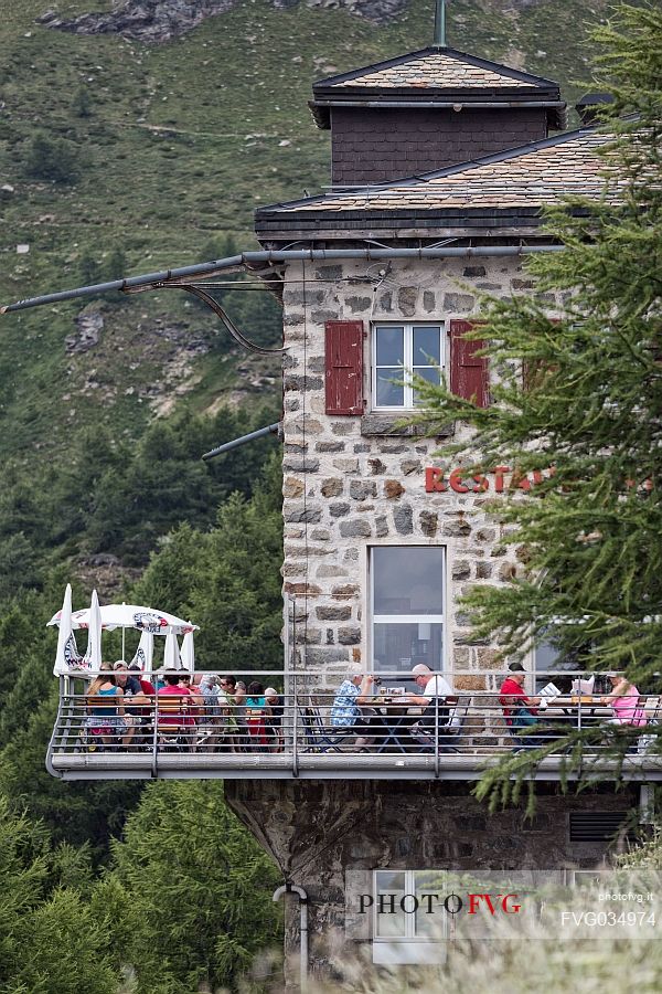 Tourists at the restaurant of the Alp Grum railway station, Rhaetian Railway, Poschiavo valley, Engadin, Canton of Grisons, Switzerland, Europe