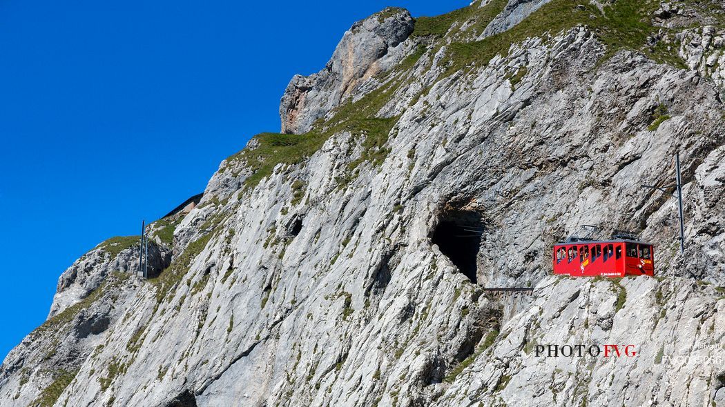 The red Cogwheel Railway going up Pilatus Mountain, Border Area between the Cantons of Lucerne, Nidwalden and Obwalden, Switzerland, Europe