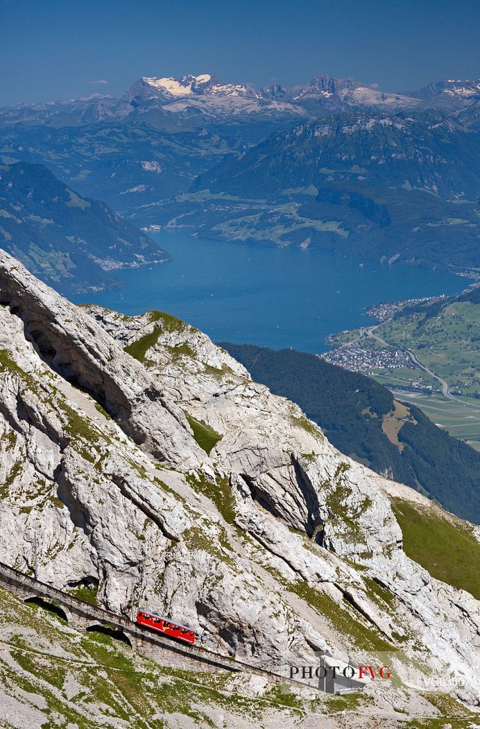 The red Cogwheel Railway going up Pilatus Mountain, in the background the Lucerna lake, Border Area between the Cantons of Lucerne, Nidwalden and Obwalden, Switzerland, Europe