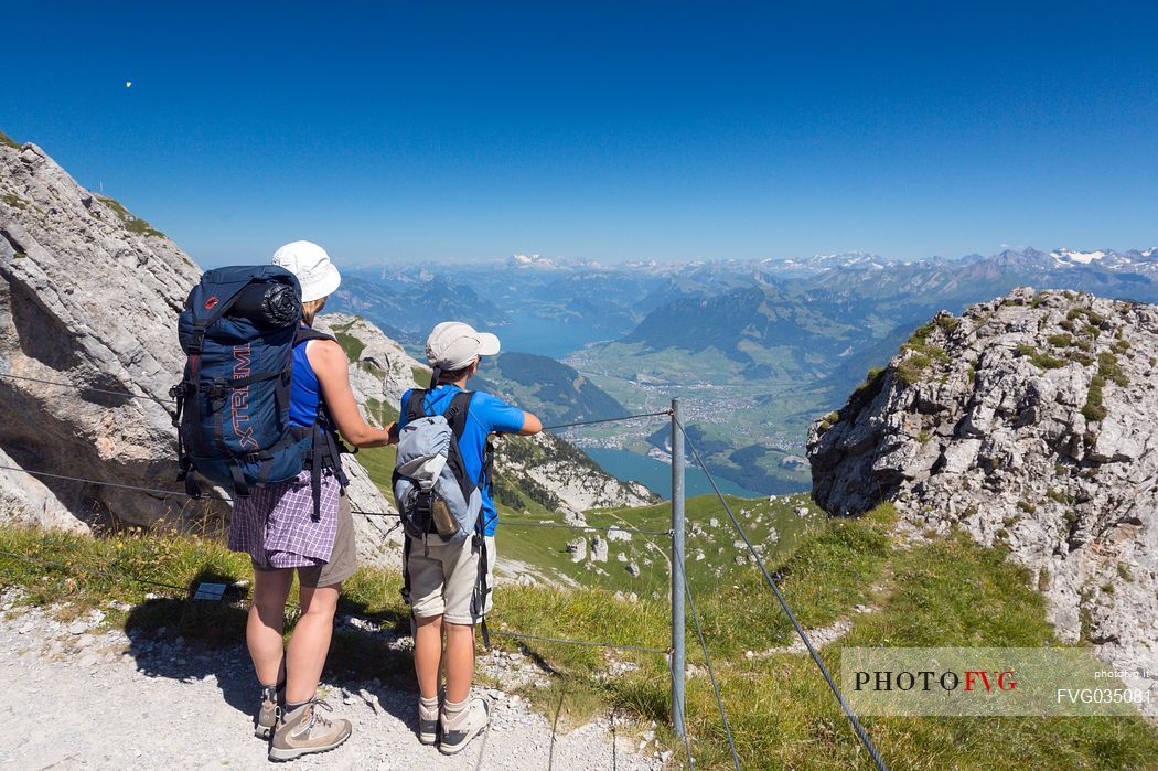 Hikers on the Pilatus mountainn area, in the background the Lucerne lake,  Border Area between the Cantons of Lucerne, Nidwalden and Obwalden, Switzerland, Europe