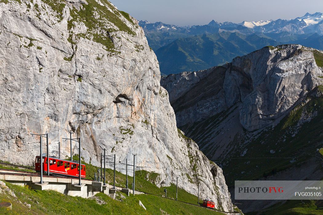 The red Cogwheel Railway going up Pilatus Mountain, Border Area between the Cantons of Lucerne, Nidwalden and Obwalden, Switzerland, Europe