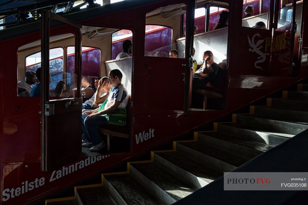 Tourists inside the Cogwheel Railway of Pilatus Mount, Border Area between the Cantons of Lucerne, Nidwalden and Obwalden, Switzerland, Europe