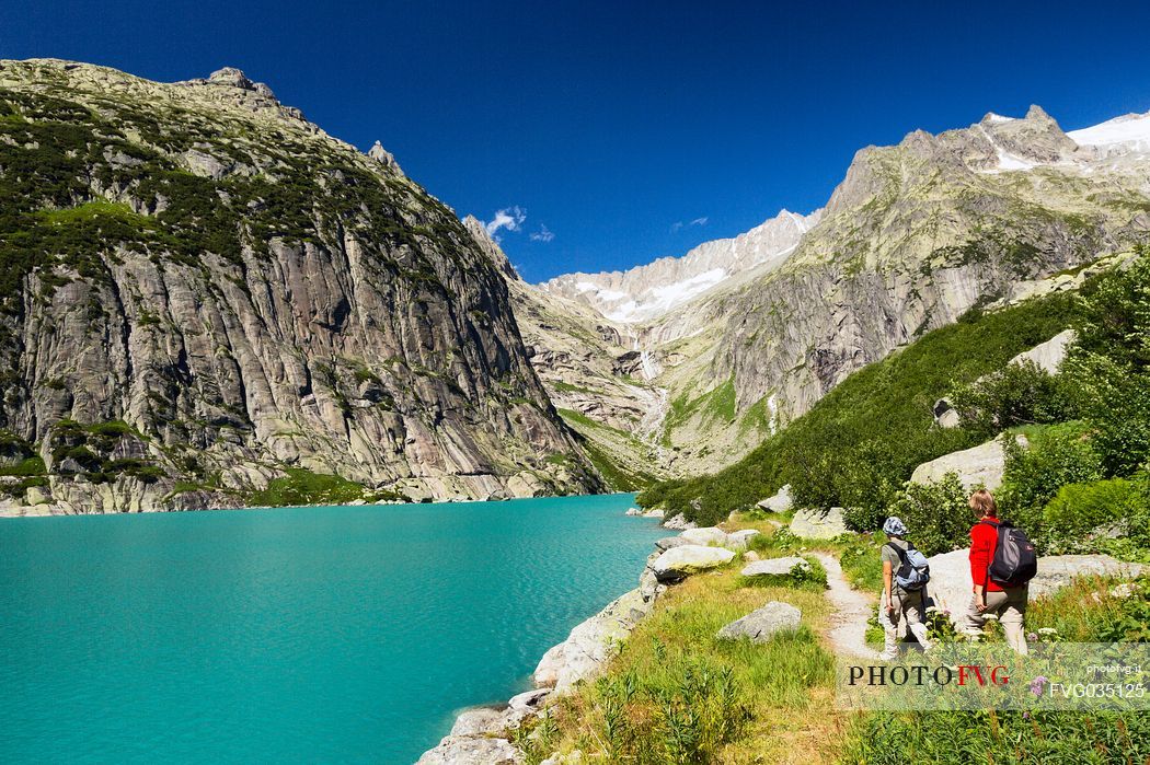 Hiking at the Gelmer lake, Gelmersee, a hydroelectric reservoir, Canton of Berne, Switzerland, Europe