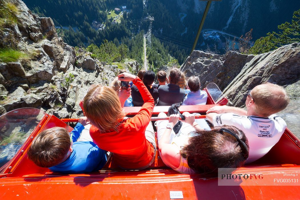 Tourist photographs the steep descent from the Gelmer funicular, the steepest in the world, Canton of Bern, Switzerland, Europe
