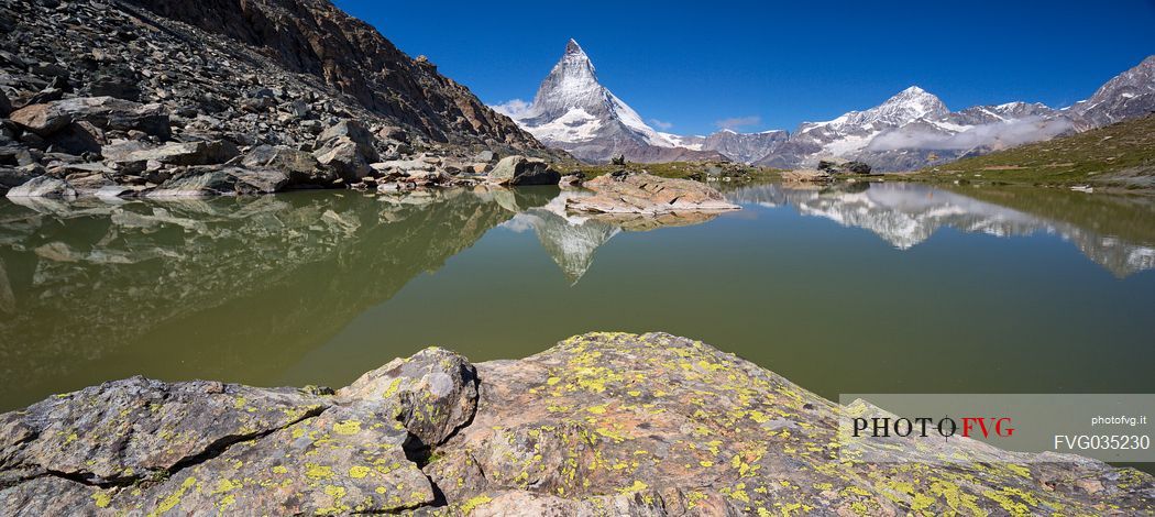 The Matterhorn or Cervino mount reflected in the Riffelsee Lake (Riffel lake), Gornergrat, Zermatt, Valais, Switzerland, Europe
 