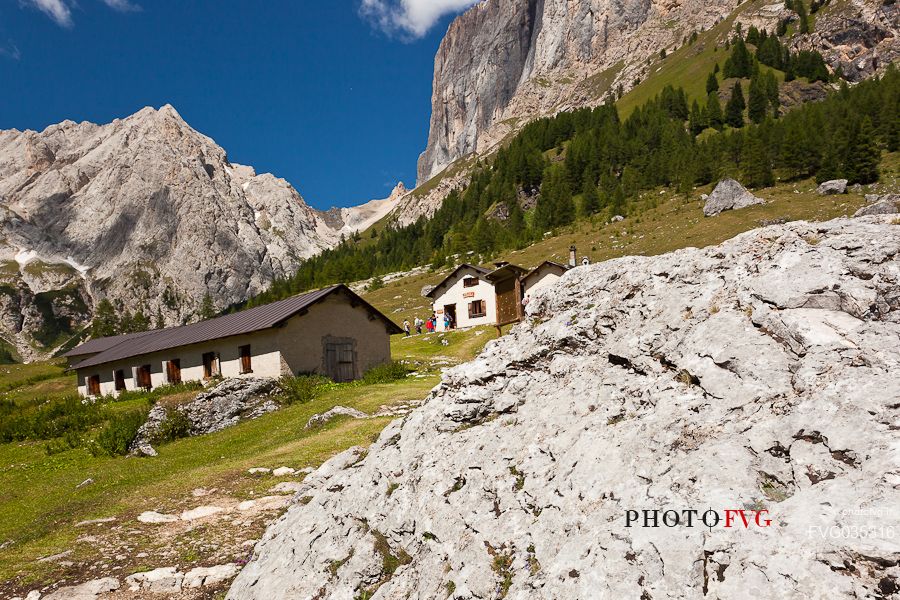 Ombretta alm and in the background the Ombretta peak and the south cliff of Marmolada, Rocca Pietore, dolomites, Veneto, Italy, Europe