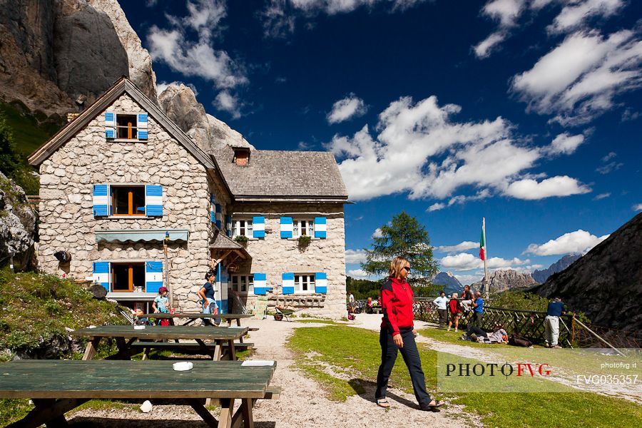 Hiker at the Rifugio Falier hut, below at the south cliff of Marmolada, Val Ombretta, dolomites, Veneto, Italy, Europe