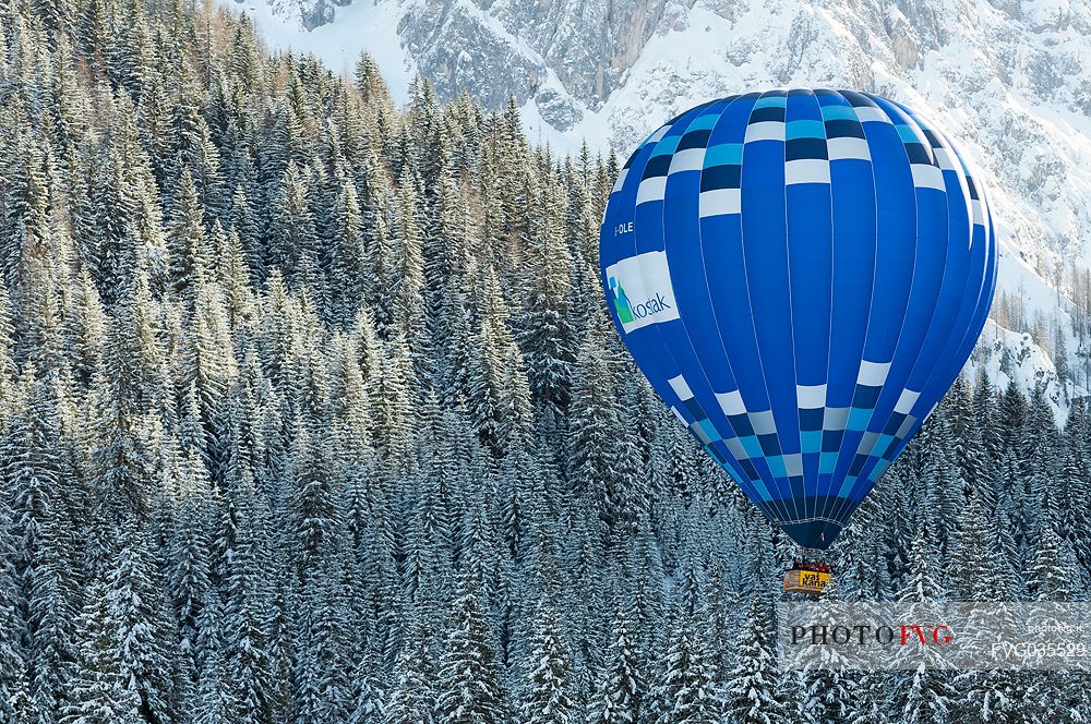 Hot air balloon flying over the Fiscalina valley during the balloon festival of Dobbiaco, Pusteria valley, dolomites, Trentino Alto Adige, Italy, Europe