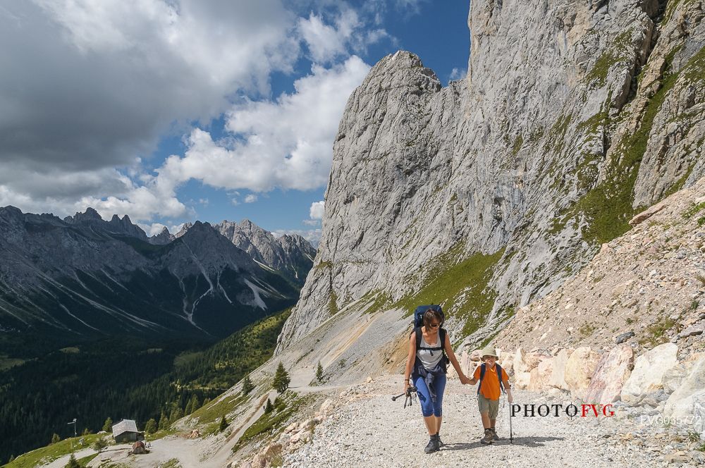 Mother and child walking in Sesis valley, Sappada, dolomites, Friuli Venezia Giulia, Italy, Europe