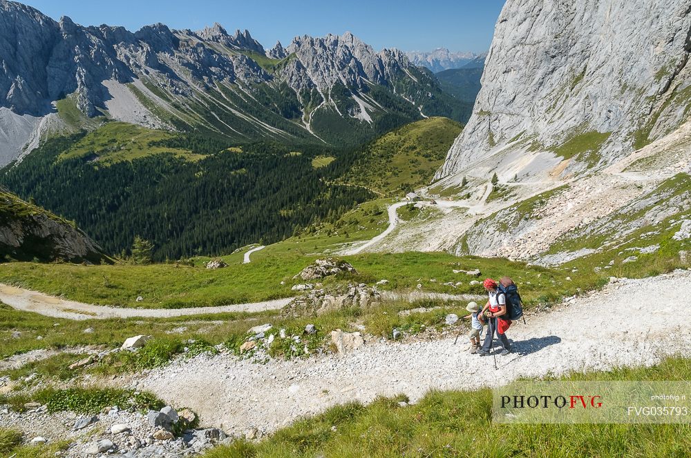 Mother and child walking in Sesis valley, Sappada, dolomites, Friuli Venezia Giulia, Italy, Europe