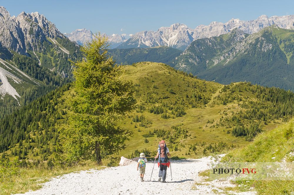 Mother and child near the source of the Piave river and in the background the dolomites of Cadore, Sappada, dolomites, Friuli Venezia Giulia, Italy, Europe