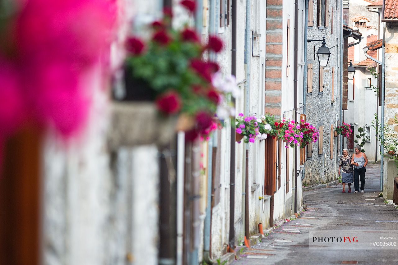 Women walking in the alley of the small village of Andreis, Friuli Venezia Giulia, dolomites, Italy, Europe