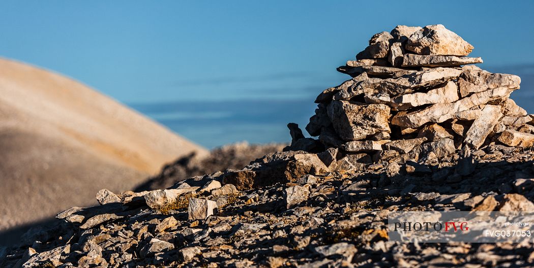 Pile of rocks on the top of Focalone mount, in the background the slope of Acquaviva mount, amphitheater of the Murelle, Majella national park, Abruzzo, Italy, Europe