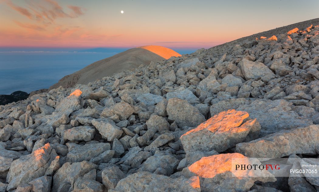 Moon and sunrise at the Mount Acquaviva in the amphitheater of the Murelle, Majella national park, Abruzzo, Italy, Europe