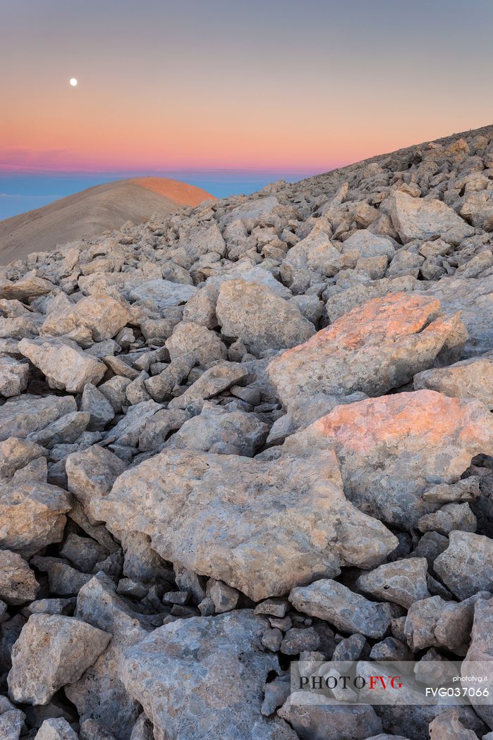 Moon and sunrise at the Mount Acquaviva in the amphitheater of the Murelle, Majella national park, Abruzzo, Italy, Europe