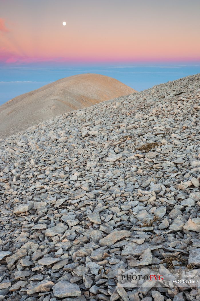 The moon rise over the Mount Acquaviva in the amphitheater of the Murelle, Majella national park, Abruzzo, Italy, Europe