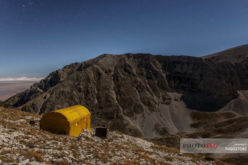 Carlo Fusco hut and the amphitheater of the Murelle at moonlight, Majella national park, Abruzzo, Italy, Europe