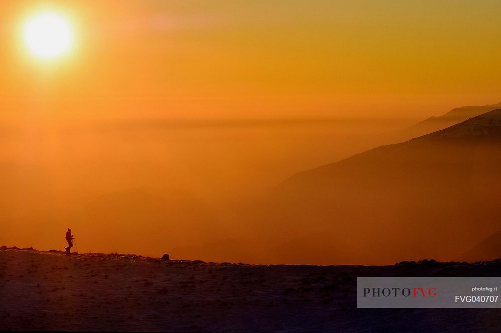 Hiking with snowshoe on the top of Pizzoc mount, Cansiglio plateau, Veneto, Italy, Europe