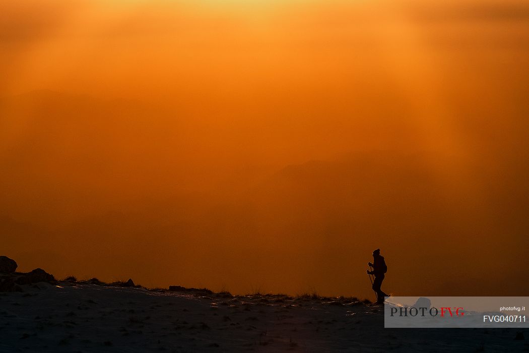 Hiking with snowshoe on the top of Pizzoc mount, Cansiglio plateau, Veneto, Italy, Europe