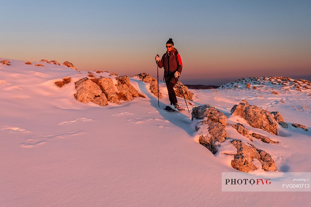 Hiking with snowshoe on the top of Pizzoc mount, Cansiglio plateau, Veneto, Italy, Europe