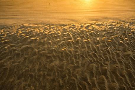 The gold sand of the beach in front of Bamburgh castle