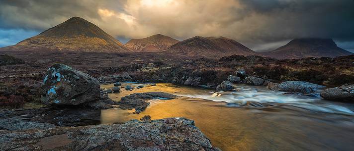 Sligachan waterfalls and the black cuillins in the background at sunset