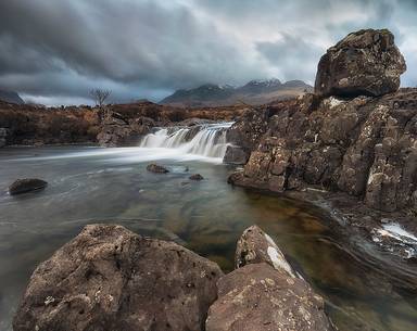 Sligachan waterfalls and the black cuillins in the background at sunset